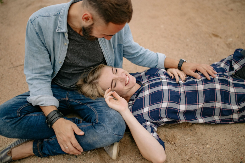 Man and woman together on the sand.